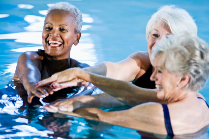 Multiracial senior women in water aerobics class